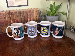 Set of mugs with custom labels each featuring a Musician’s album covers on white ceramic mugs.
