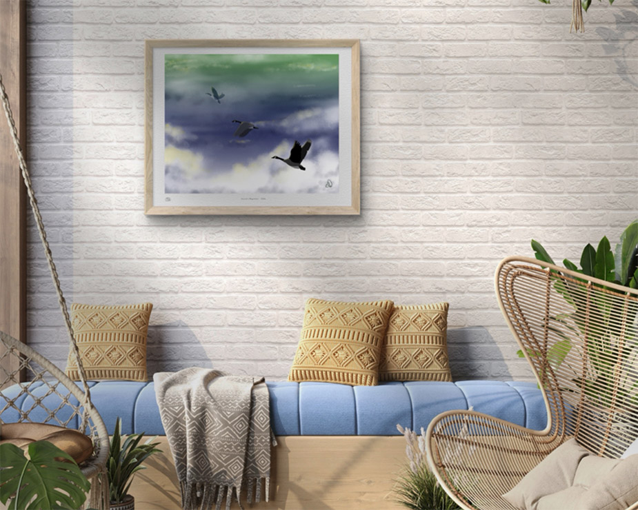Canada geese painting framed on a white brick wall above a blue couch.